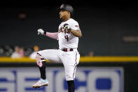 Arizona Diamondbacks Ketel Marte (4) celebrates towards his dugout after hitting a double against the Atlanta Braves during the first inning of a baseball game, Monday, Sept. 20, 2021, in Phoenix. (AP Photo/Matt York)