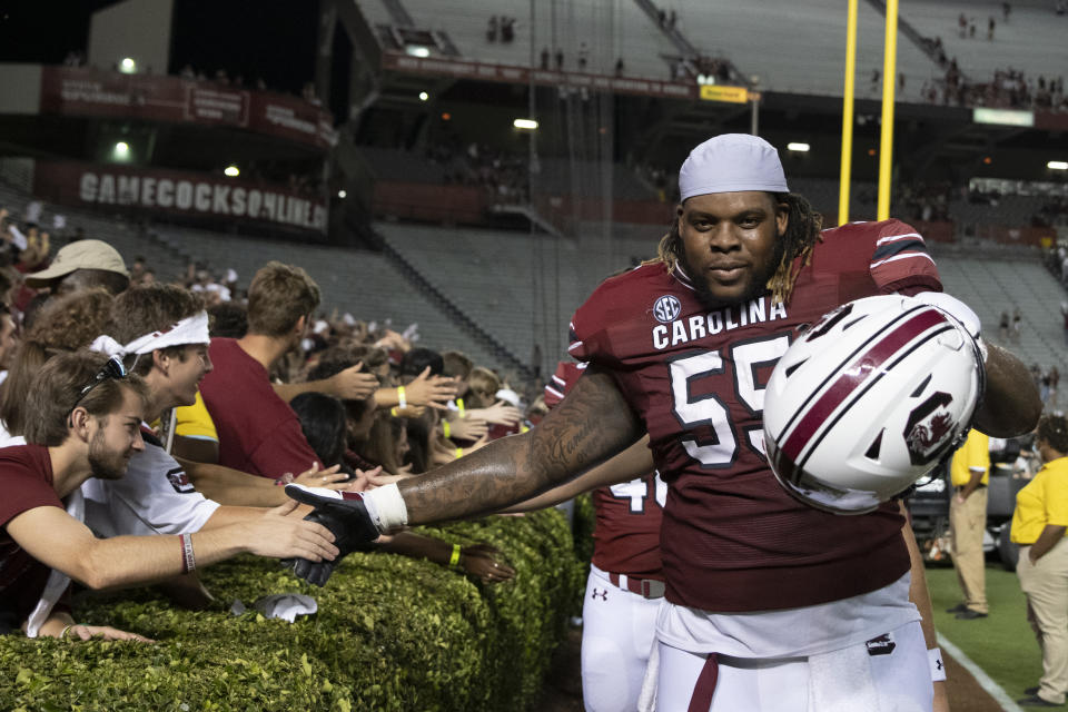 South Carolina offensive lineman Jakai Moore (55) celebrates with fans a victory over Eastern Illinois in an NCAA college football game on Saturday, Sept. 4, 2021, in Columbia, S.C. (AP Photo/Hakim Wright Sr.)