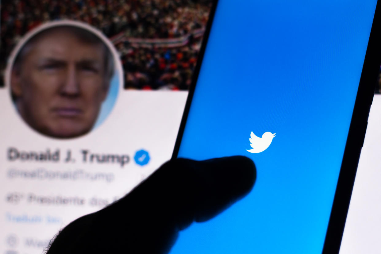 BRAZIL - 2020/06/05: In this photo illustration the Twitter logo seen displayed on a smartphone with the official page of the President of the United States, Donald Trump.  Platform may suspend account of the American politician. (Photo Illustration by Rafael Henrique/SOPA Images/LightRocket via Getty Images)