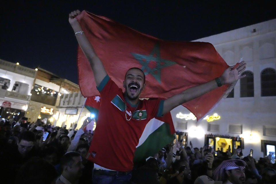 People celebrate in the Souq in Doha, Qatar after Morocco beat Portugal in a World Cup quarterfinal soccer match at Al Thumama Stadium in Doha, Qatar, Saturday, Dec. 10, 2022. (AP Photo/Jorge Saenz)