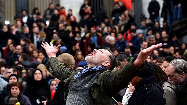 A man mourns as he pays his respects with thousands of others in Place De La Bourse. Photo: Getty Images