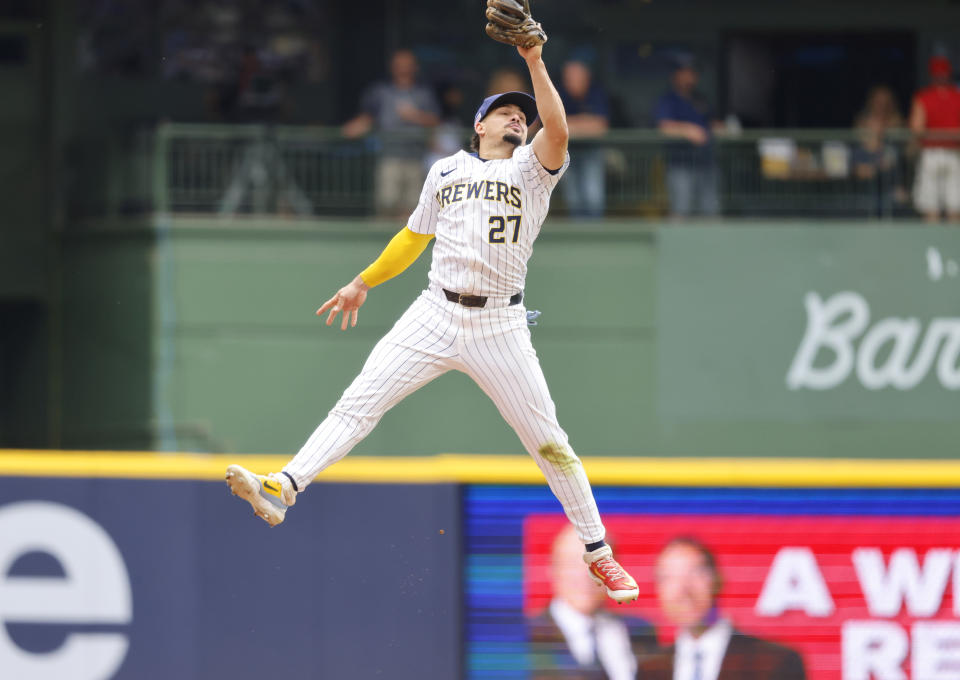 Milwaukee Brewers' Willy Adames makes a leaping catch on a ball hit by the Cincinnati Reds' Stuart Fairchild in the seventh inning of a baseball game Saturday, June 15, 2024, in Milwaukee. (AP Photo/Jeffrey Phelps)