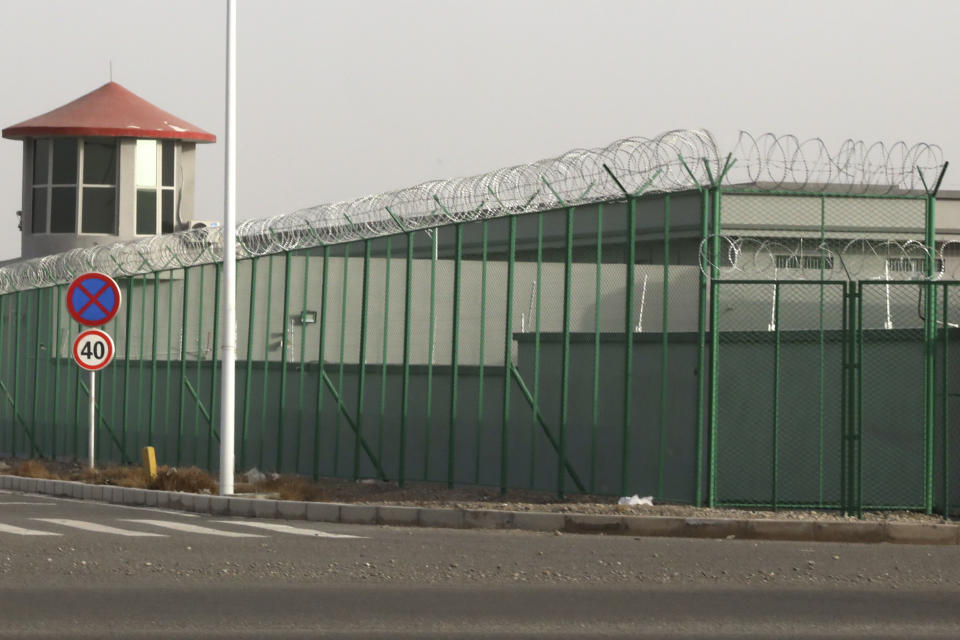 In this Monday, Dec. 3, 2018, file photo, a guard tower and barbed wire fences are seen around a facility in the Kunshan Industrial Park in Artux in western China's Xinjiang region. People in touch with state employees in China say the government in the far west region of Xinjiang is destroying documents and taking other steps to tighten control on information. (AP Photo/Ng Han Guan, File)