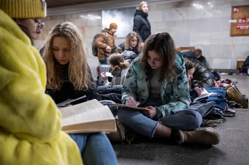 FILE PHOTO: School students attend a lesson as they take shelter inside a metro station during massive Russian missile attacks in Kyiv