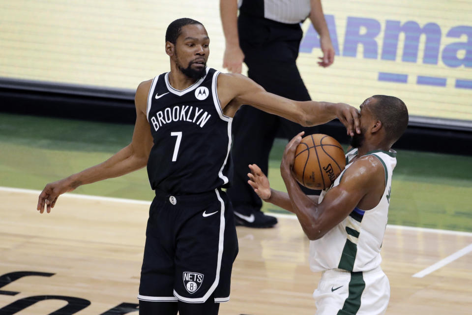 Milwaukee Bucks' Khris Middleton, right, steals the ball from Brooklyn Nets' Kevin Durant (7) during the second half of an NBA basketball game Tuesday, May 4, 2021, in Milwaukee. (AP Photo/Aaron Gash)