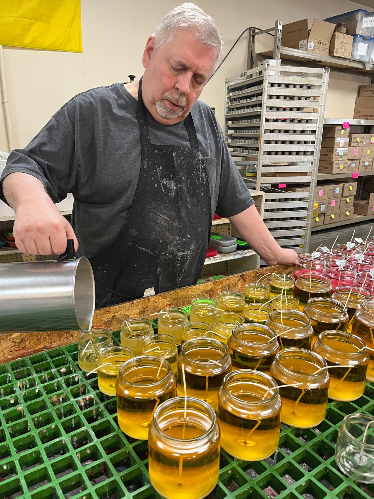 Larry Mickelson pours candles at Door County Candle Co., which announced Friday it will donate a portion of proceeds from the sale of any of the scented wax products it makes to selected nonprofits and charities.