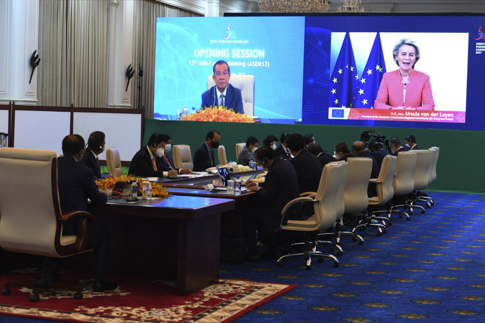 In this photo provided by An Khoun Sam Aun/Ministry of Information of Cambodia, Cambodian Prime Minister Hun Sen, upper left, Ursula von der Leyen, Upper right, President of the European Commission, as the Regional Coordinator for European Group, are seen on the screen during an online opening session of the Asia-Europe Meeting (ASEM) in Phnom Penh, Cambodia, Thursday, Nov. 25, 2021. Hun Sen on Thursday welcomed leaders of Asian and European nations to the 13th biennial Asia-Europe Meeting, held virtually and postponed from last year due to the coronavirus pandemic. (An Khoun Sam Aun/Ministry of Information of Cambodia via AP)