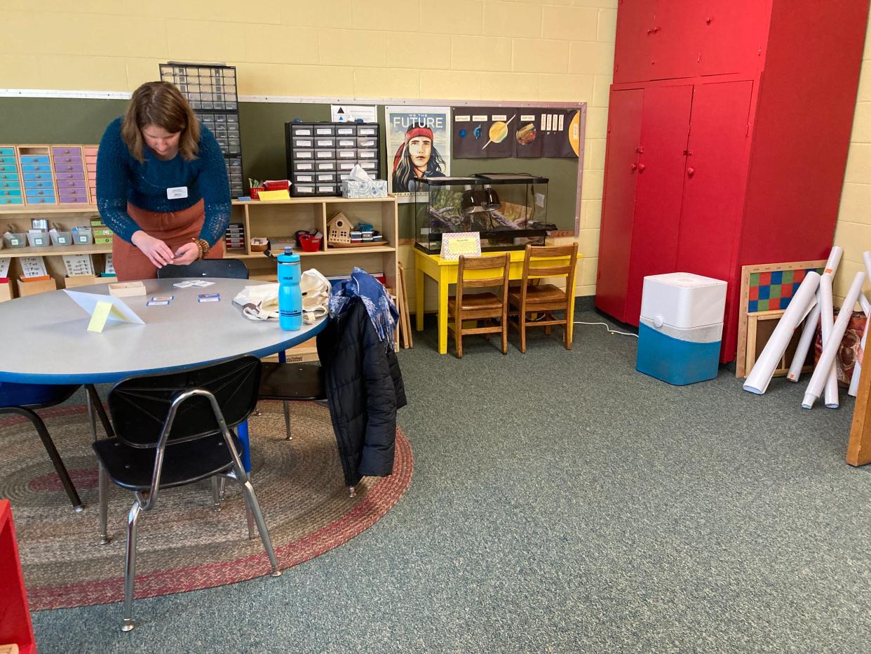Sasha Skau sets up at a Feb. 4, 2023 open house for Mountain City Public Montessori in downtown Asheville.