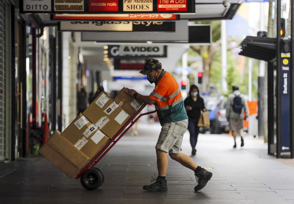 A courier delivers goods to a store in central Auckland, New Zealand, Monday, Nov. 8, 2021. The lockdown of New Zealand's largest city Auckland, for almost three months after an outbreak of the delta variant, is likely to end later this month, with some coronavirus restrictions being eased Tuesday, Nov. 9. (Dean Purcell/NZ Herald via AP)