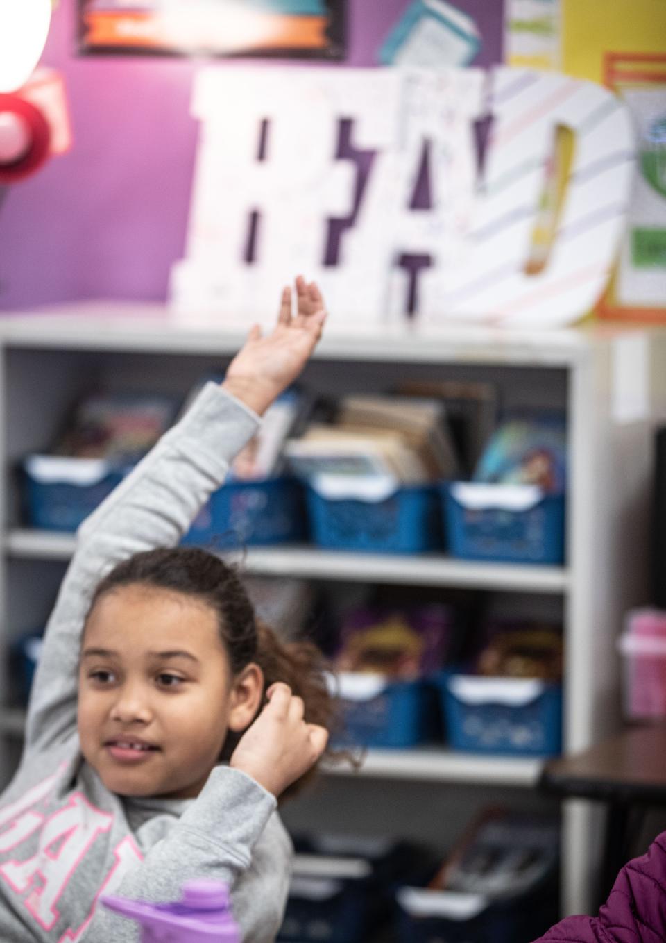 Layla Guzman, a fourth grader at the Cross Hill Academy, raises her hand during a reading lesson Jan. 8, 2023.