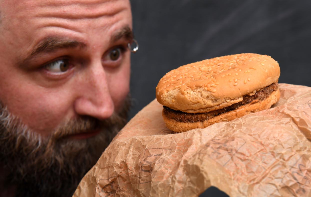 Casey Dean inspects a McDonald's burger he bought in 1995.