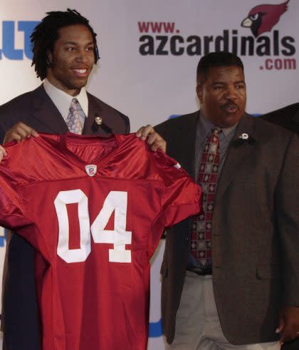 Dennis Green, right, drafted Larry Fitzgerald, left, and Randy Moss in his NFL career. (AP)