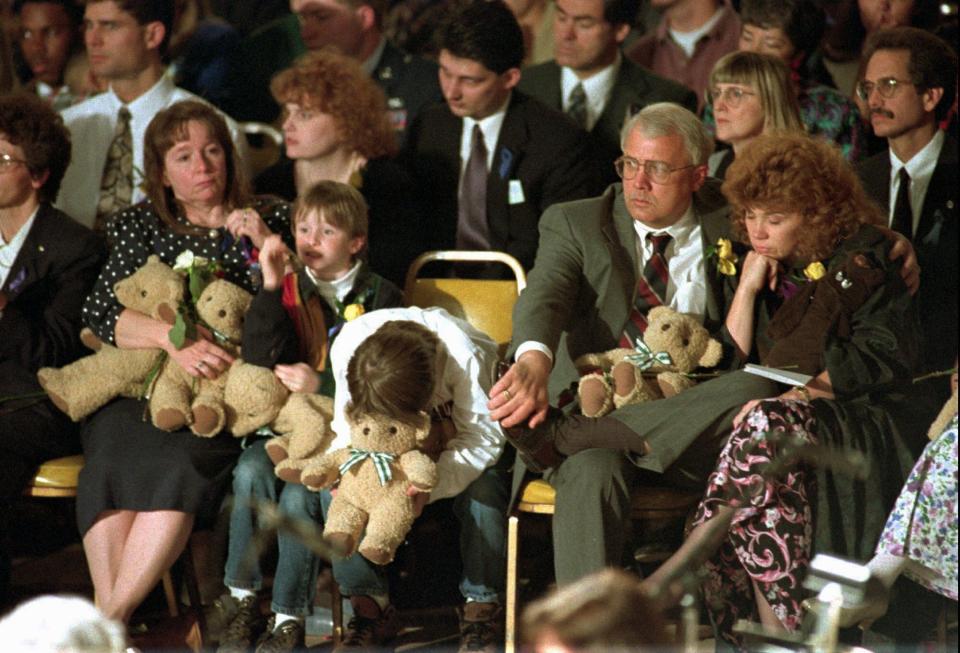 FILE - In this Sunday, April 23, 1995 file photo, an unidentified boy leans over during the prayer service where some 20,000 people overflowed the State Fairgrounds. President Clinton and the Rev. Billy Graham addressed the memorial service on what the president declared a national day of mourning. (AP Photo/Beth A Keiser)