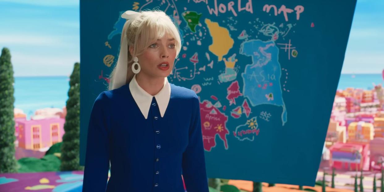 barbie trailer showing margot robbie as barbie in front of a drawing of a map