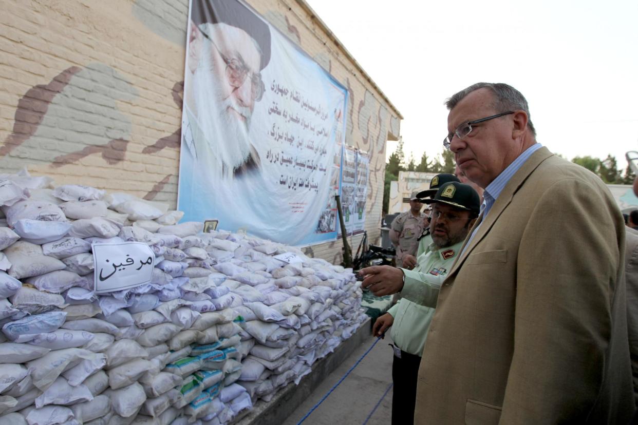 Executive director of the UN office on drugs and crime (UNODC) Yury Fedotov (R) and Iranian anti-narcotics police chief Hamidreza Housein Abadi look at bags of Afghan-made morphine on display during a media tour in the southeastern city of Zahedan, on 19 July 2011: AFP/Getty Images