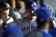 New York Mets' Mark Vientos is congratulated in the dugout for his home run against the Cleveland Guardians during the fifth inning of a baseball game Tuesday, May 21, 2024, in Cleveland. (AP Photo/Sue Ogrocki)