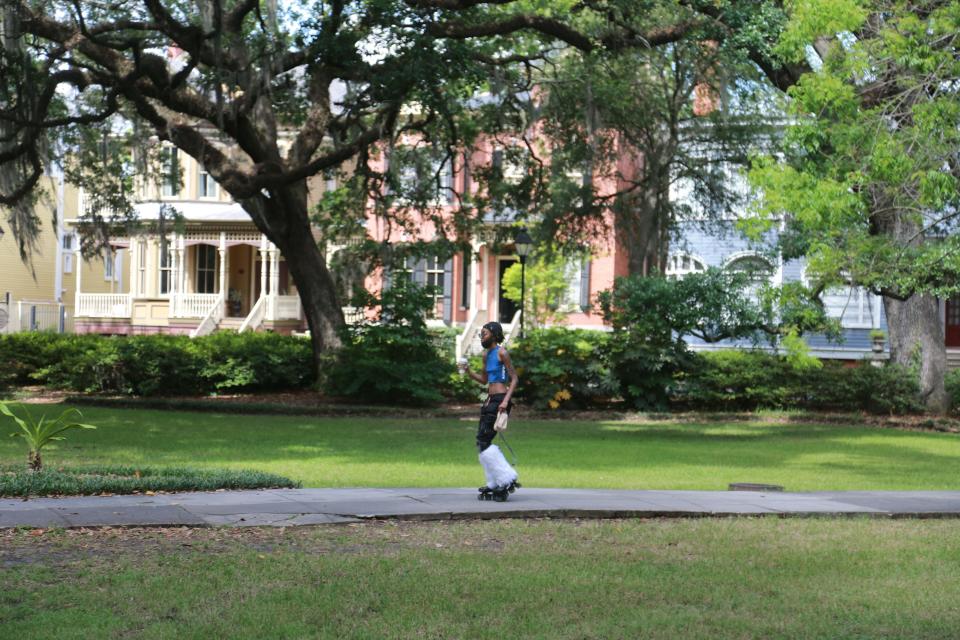 A visitor skates through Forsyth Park.