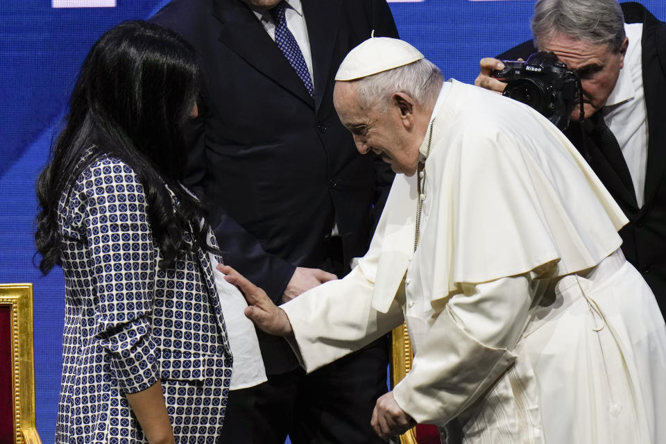 Pope Francis greets a pregnant woman at the end of a conference to discuss the "demographic winter" and "empty cribs" problem Italy is facing. Panel introduced by Gigi De Palo, president of Birth Rate Foundation, at Auditorium della Conciliazione, in Rome, Friday, May 12, 2023. (AP Photo/Alessandra Tarantino)