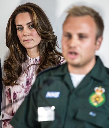 Britain's Kate, The Duchess of Cambridge listens to ambulance team member Dan Farnworth speak of his mental ordeal following witnessing a traumatic situation at a reception of the mental health charity "Heads together" on world mental health day in London, Britain October 10, 2016. REUTERS/Richard Pohle/Pool