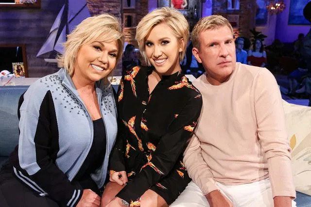 <p>Vivian Zink/NBC/NBCU Photo Bank via Getty </p> Savannah Chrisley with her parents Todd and Julie Chrisley