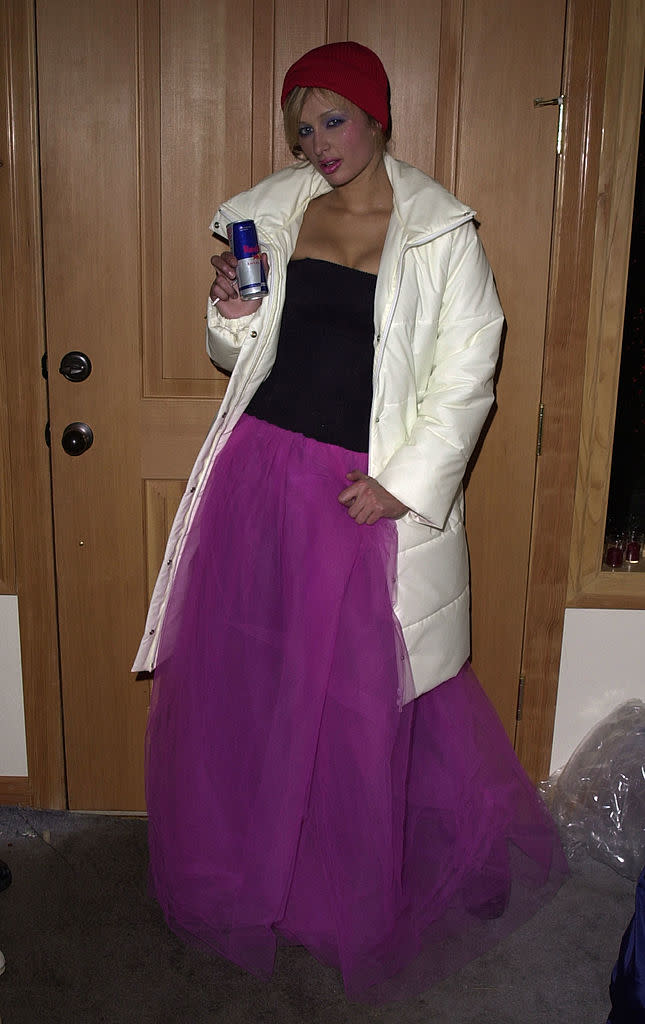 Paris Hilton displays a can of Red Bull while wearing a princess skirt and ski parka.