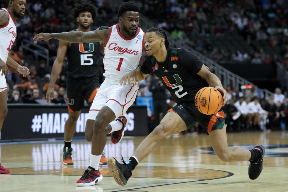 Miami guard Isaiah Wong drives to the basket past Houston guard Jamal Shead in the first half of a Sweet 16 college basketball game in the Midwest Regional of the NCAA Tournament Friday, March 24, 2023, in Kansas City, Mo. (AP Photo/Jeff Roberson)