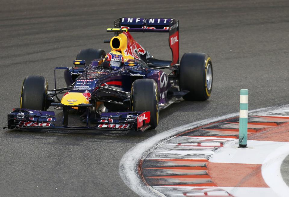 Red Bull Formula One driver Mark Webber of Australia takes a corner during the qualifying session of the Abu Dhabi F1 Grand Prix at the Yas Marina circuit on Yas Island, November 2, 2013. Webber put Red Bull on pole position for the floodlit Abu Dhabi Formula One Grand Prix on Saturday in a front row sweep with quadruple world champion team mate Sebastian Vettel. REUTERS/Steve Crisp (UNITED ARAB EMIRATES - Tags: SPORT MOTORSPORT SPORT MOTORSPORT F1)