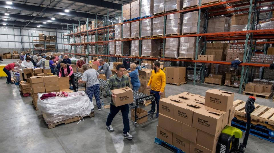 The new York County Food Bank warehouse, in Manchester Township, is busy with 35 volunteers packing 1080 boxes for the regular food distribution. 