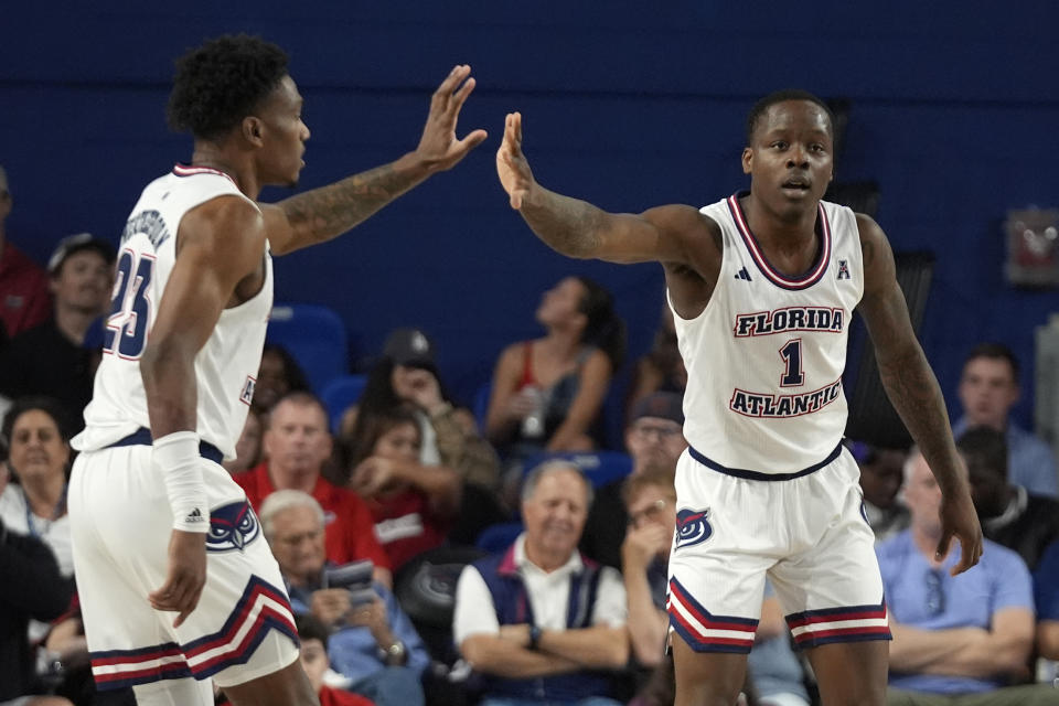 Florida Atlantic guard Johnell Davis (1) is congratulated by guard Brandon Weatherspoon (23) after scoring during the first half of an NCAA college basketball game against North Texas, Sunday, Jan. 28, 2024, in Boca Raton, Fla. (AP Photo/Wilfredo Lee)