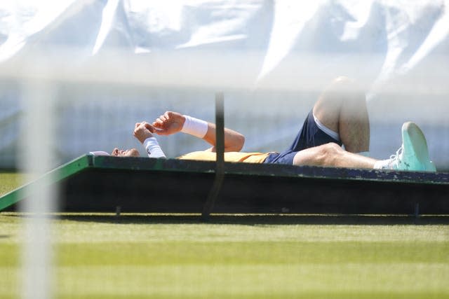 Andy Murray crashes through an advertising board