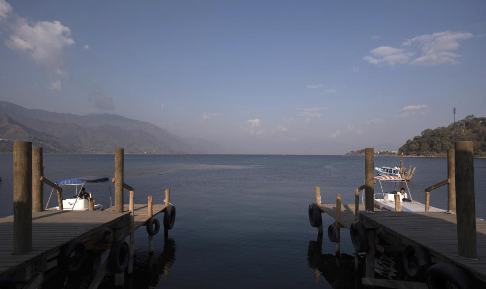 Boats are docked at the Mayan Tz'utujil community of San Juan La Laguna, lake Atitlan, Guatemala, Tuesday, March 12, 2019. An English tourist whose body was found near the Guatemala highland lake popular with travelers died of hemorrhaging resulting from a traumatic brain injury, according to an autopsy report completed Tuesday. (AP Photo/Santiago Billy)