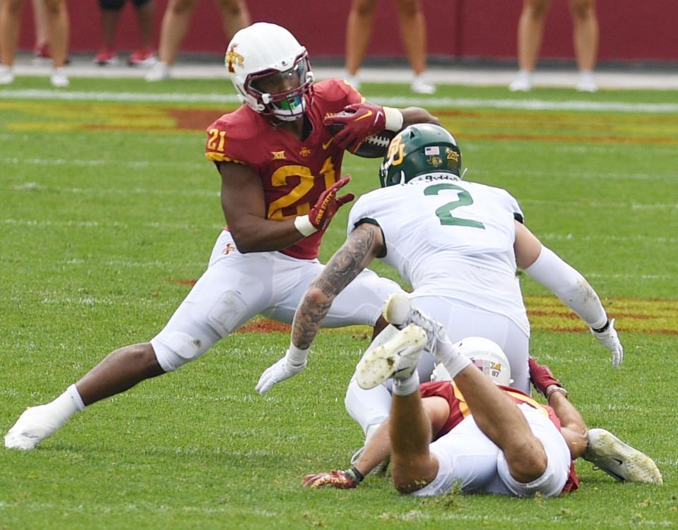 Iowa State running back Jirehl Brock (21) runs with the ball around Baylor linebacker Matt Jones (2) during the third quarter at Jack Trice Stadium on Saturday.