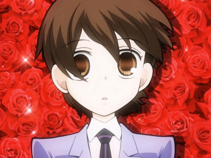 haruhi fujioka in ouran high school host club. she's an animated teenager with short cropped brown hair and a blue suit, with roses behindher