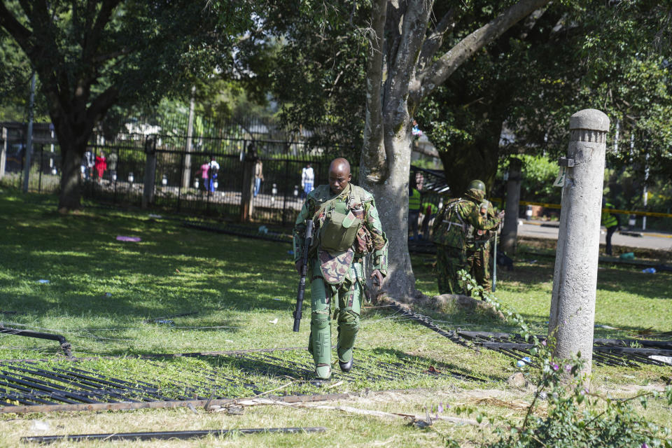 Kenya anti riot police patrol around parliament compound in downtown Nairobi, Kenya, Wednesday, June 26, 2024. Thousands of protesters stormed and burned a section of Kenya's parliament Tuesday to protest tax proposals. Police responded with gunfire and several protesters were killed. (AP Photo/Brian Inganga)