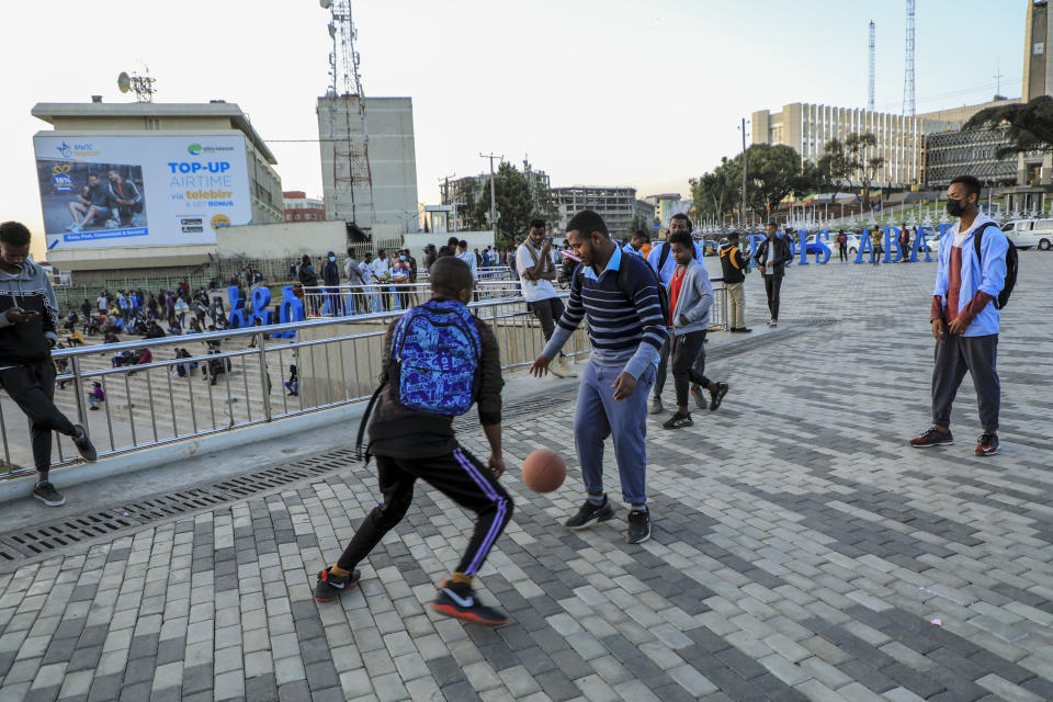 People play with a ball in the Piazza old town area of the capital Addis Ababa, Ethiopia Thursday, Nov. 4, 2021. Urgent new efforts to calm Ethiopia's escalating war are unfolding Thursday as a U.S. special envoy visits and the president of neighboring Kenya calls for an immediate cease-fire while the country marks a year of conflict. (AP Photo)