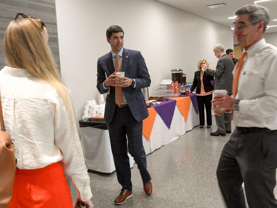 Graham Neff, middle, Athletic Director, leaves during executive session, after giving a the Clemson Athletics Business Update during the Clemson University Board of Trustees meeting at the School of Business Friday, July 22, 2022. 