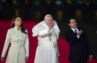 Pope Francis (C) is greeted by Mexican President Enrique Pena Nieto and First Lady Angelica Rivera upon his arrival at Benito Juarez international airport in Mexico City, on February 12, 2016