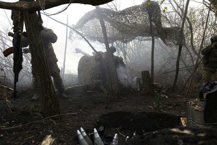 Ukrainian artillerymen of Aidar battalion fire a 122mm D30 howitzer artillery field gun, at a front line near Bakhmut, in the Donetsk region, on 22 April 2023 (AFP via Getty Images)