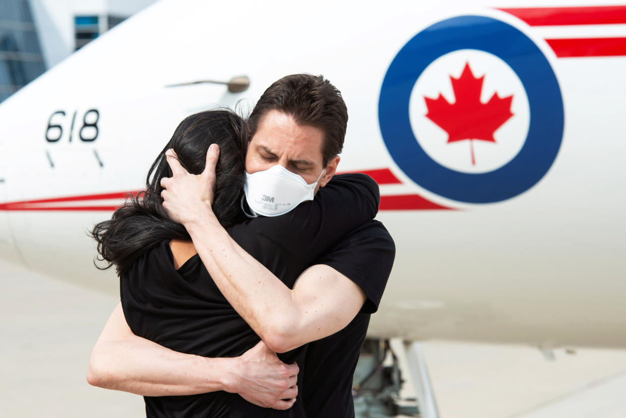 Image: Former diplomat Michael Kovrig embraces his wife Vina Nadjibulla (Cpl. Justin Dreimanis / DND-MDN Canada via Reuters)