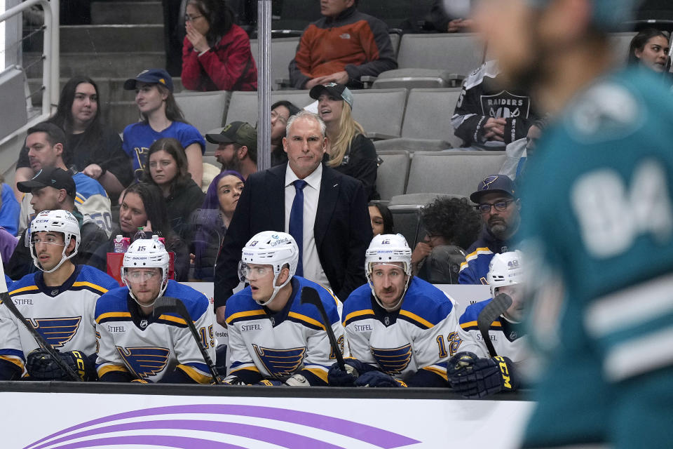 St. Louis Blues coach Craig Berube watches from the beach during the first period of the team's NHL hockey game against the San Jose Sharks on Thursday, Nov. 16, 2023, in San Jose, Calif. (AP Photo/Tony Avelar)