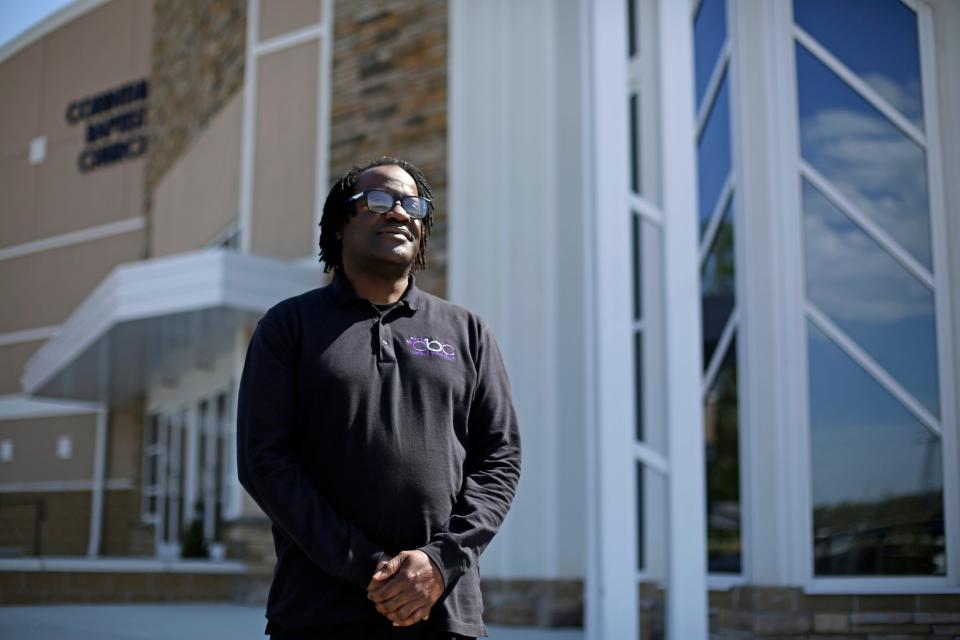 Minister Bomani Tyehimba poses in front of the Corinthian Baptist Church in the Bond Hill neighborhood of Cincinnati on Wednesday, April 22, 2020. Tyehimba recently helped lead a voter drive through his church to encourage more people from the area to vote. 