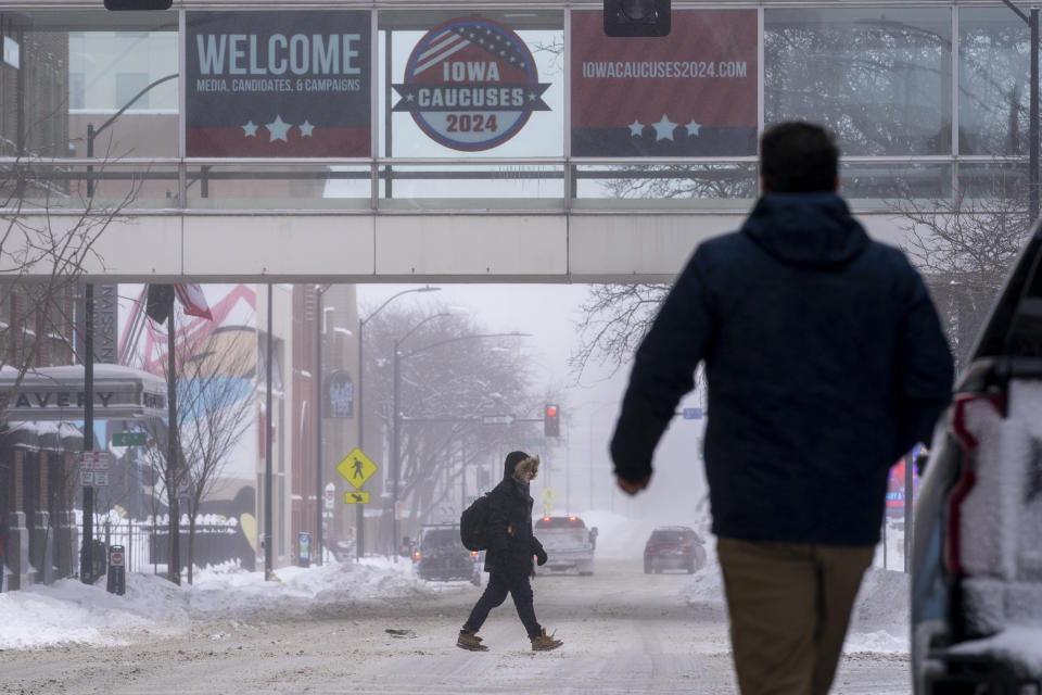 People walk across the street in downtown Des Moines, Iowa, Saturday, Jan. 13, 2024. (AP Photo/Andrew Harnik)