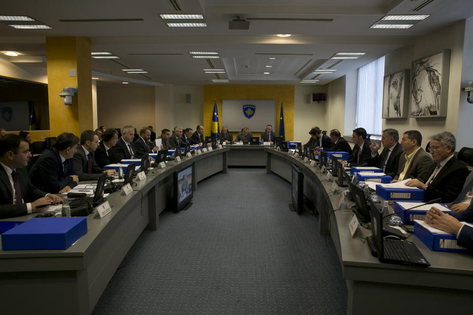 Kosovo prime minister Ramush Haradinaj, center, holds government meeting in Kosovo capital Pristina on Tuesday, Dec. 18, 2018. Haradinaj blamed Europe Union's foreign policy chief for "deviating the dialogue" on normalizing ties with Serbia. Haradinaj said that, while Serbia is taking major steps toward the integration with the bloc, his country's residents have remained "in a ghetto," not enjoying the visa-free travel to EU countries though it has fulfilled all requirements. (AP Photo/Visar Kryeziu)