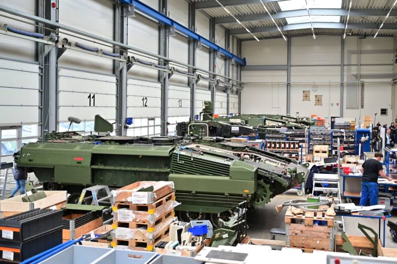 Puma infantry fighting vehicles stand in a production hall of the Rheinmetall armaments group. German Chancellor Scholz attends a symbolic ground-breaking ceremony to mark the start of construction of a new Rheinmetall ammunition factory. The ammunition factory will produce artillery ammunition, explosives and rocket artillery. Philipp Schulze/dpa