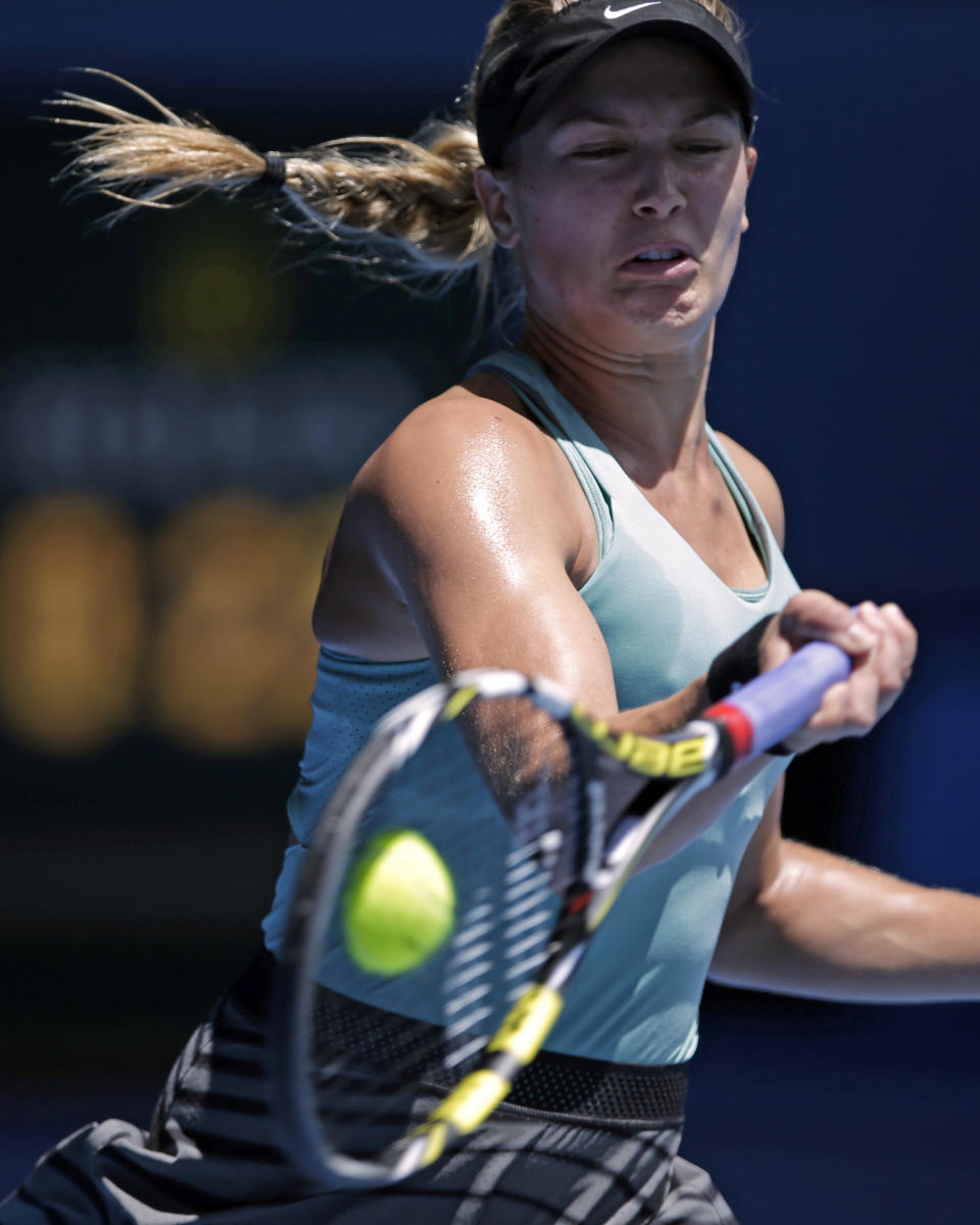 Eugenie Bouchard of Canada makes a forehand return to Ana Ivanovic of Serbia during their quarterfinal at the Australian Open tennis championship in Melbourne, Australia, Tuesday, Jan. 21, 2014. (AP Photo/Rick Rycroft)