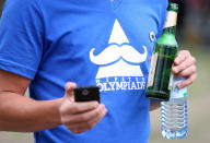 BERLIN, GERMANY - JULY 21: An attendee stands at the second annual Hipster Olympics on July 21, 2012 in Berlin, Germany. With events such as the "Horn-Rimmed Glasses Throw," "Skinny Jeans Tug-O-War," "Vinyl Record Spinning Contest" and "Cloth Tote Sack Race," the Hipster Olympics both mocks and celebrates the Hipster subculture, which some critics claim could never be accurately defined and others that it never existed in the first place. The imprecise nature of determining what makes one a member means that the symptomatic elements of adherants to the group vary in each country, but the archetype of the version in Berlin, one of the more popular locations for those following its lifestyle, along with London and Brooklyn, includes a penchant for canvas tote bags, the carbonated yerba mate drink Club Mate, analogue film cameras, an asymetrical haircut, 80s neon fashion, and, allegedly, a heavy dose of irony. To some in Berlin, members of the hipster "movement" have replaced a former unwanted identity in gentrifying neighborhoods, the Yuppie, for targets of criticism, as landlords raise rents in the areas to which they relocate, particularly the up-and-coming neighborhood of Neukoelln. (Photo by Adam Berry/Getty Images)