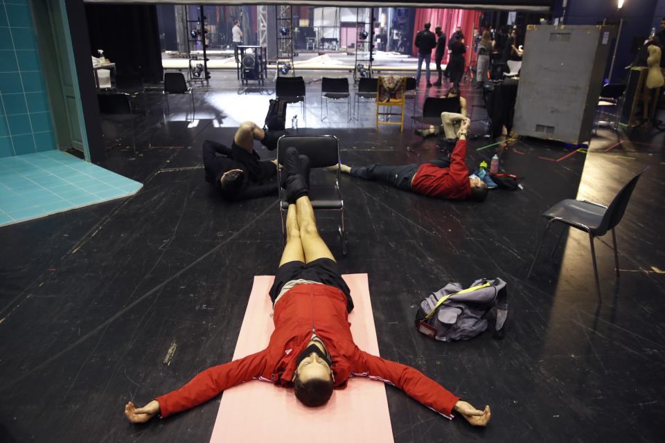 Elton Dimrochi dancer of the Greek National Opera Ballet, stretches before a rehearsal of "Despo-Greek Dances" Opera and dance performance in Athens, Thursday, March 4, 2021. Dozens of museum exhibitions, theater productions, discussion panels and historical re-enactments were planned in Greece for this year to commemorate the bicentennial of the 1821-1832 Greek War of Independence. But due to the coronavirus pandemic, mezzo-soprano Artemis Bogri and her fellow singers stepped onstage in an empty theater to perform the Greek National Opera’s new production of “Despo,” one of the events marking 200 years since the war that resulted in Greece’s independence from the Ottoman Empire and rebirth as a nation. (AP Photo/Thanassis Stavrakis)