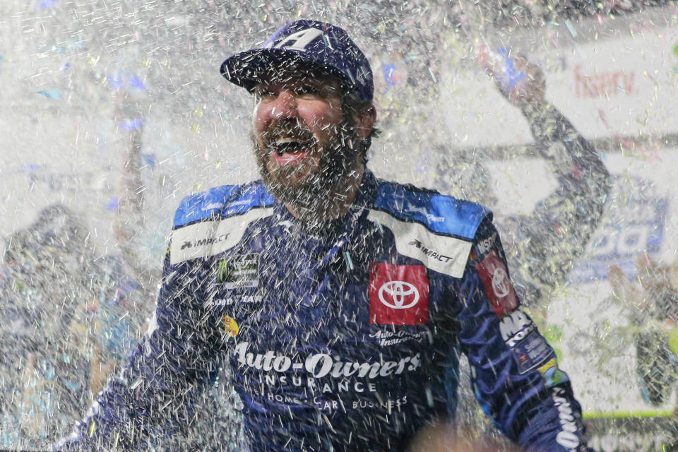 Martin Truex Jr. is doused with water and confetti after winning a NASCAR Cup Series race at Martinsville Speedway in Martinsville, Va., Sunday, Oct. 27, 2019. (AP Photo/Steve Helber)