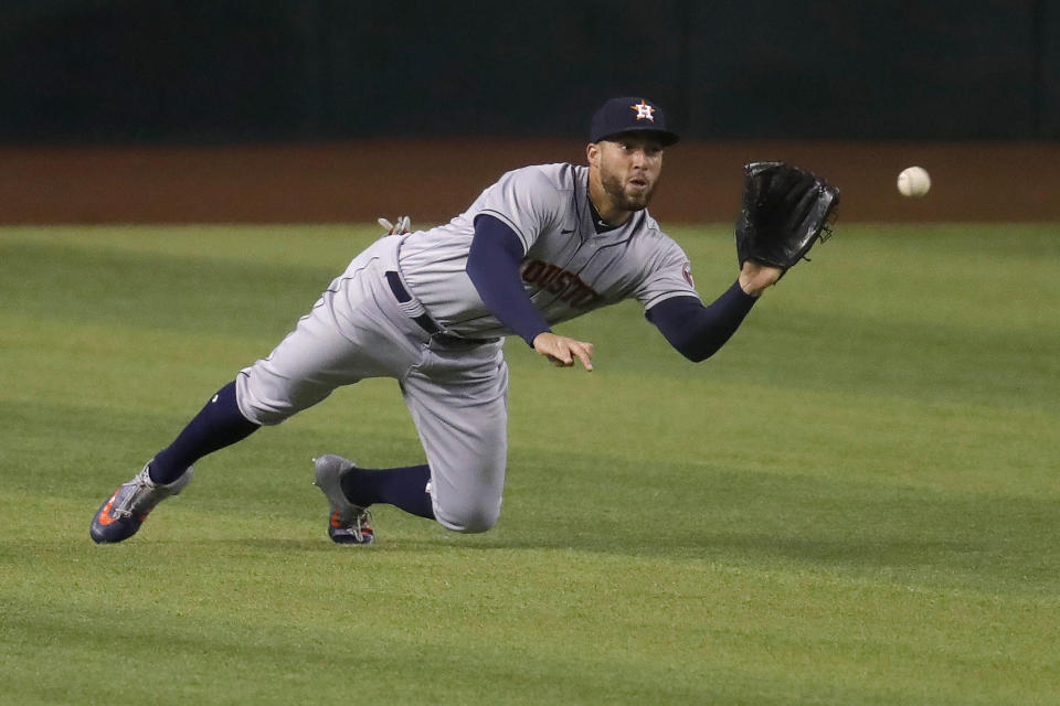 Houston Astros' George Springer catches a fly-out hit by Arizona Diamondbacks Andy Young during the fifth inning of a baseball game Thursday, Aug. 6, 2020, in Phoenix. (AP Photo/Matt York)