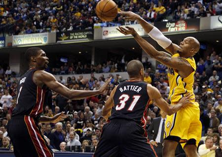 Indiana Pacers forward David West (21) makes a pass as he is double teamed by Miami Heat forward Shane Battier (31) and center Chris Bosh (1) at Bankers Life Fieldhouse. Mandatory Credit: Brian Spurlock-USA TODAY